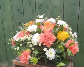 Orange and white grave posy