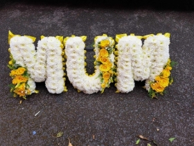 MUM  based lettering yellow spray